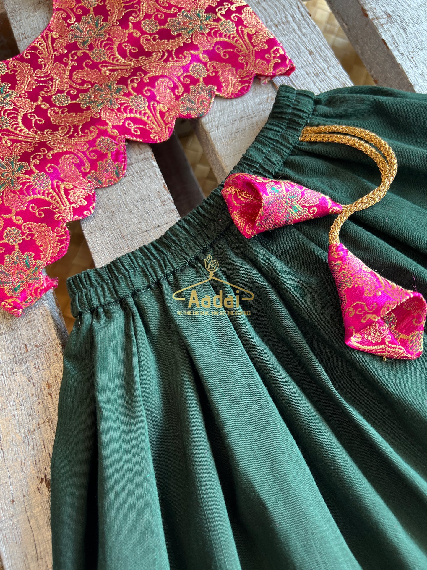 Anjana - Dark green lehengha with fuschia pink brocade top.